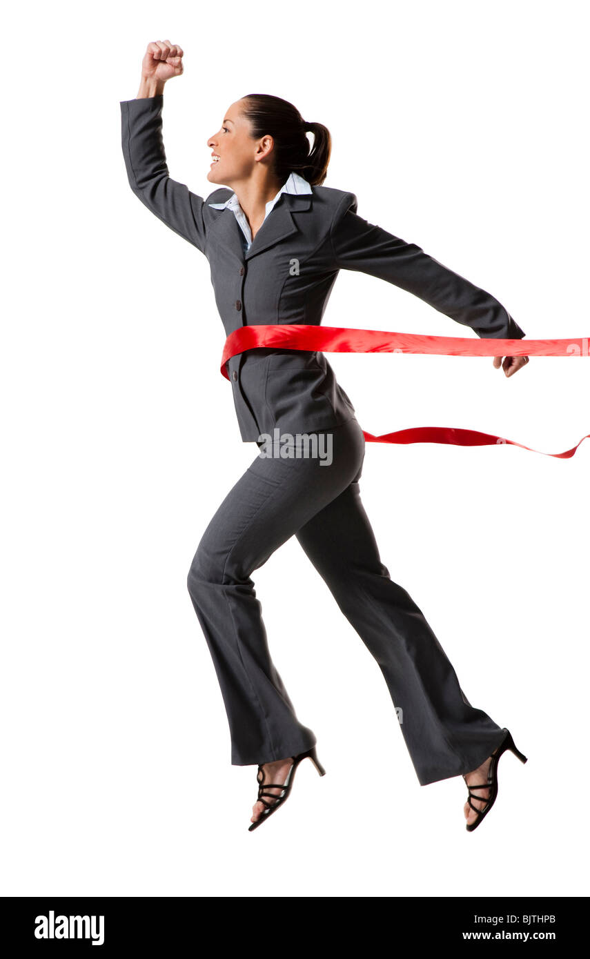 Businesswoman crossing finish line Stock Photo