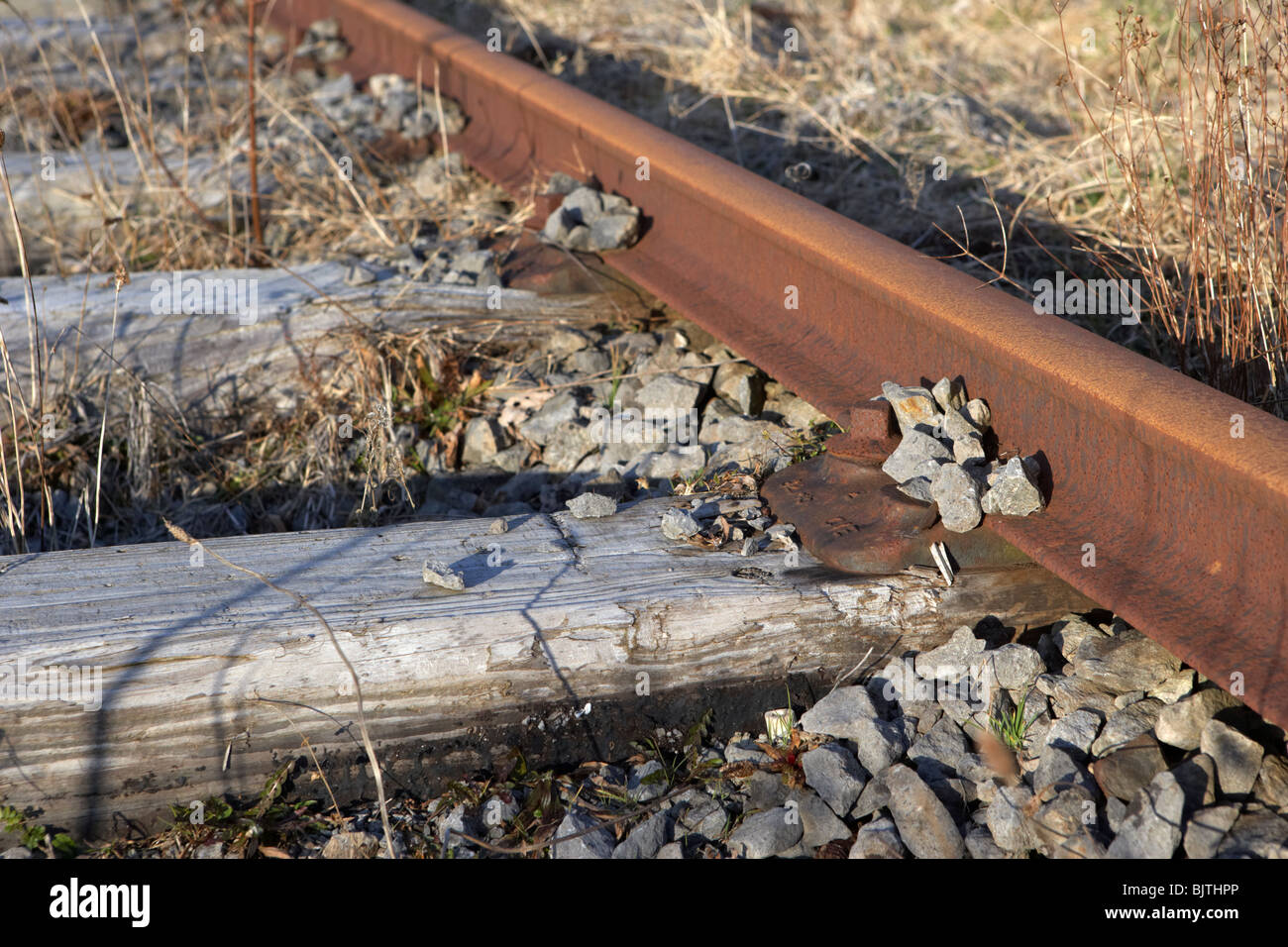 old abandoned great southern and western railway line connected to worn wooden sleepers in county sligo republic of ireland Stock Photo