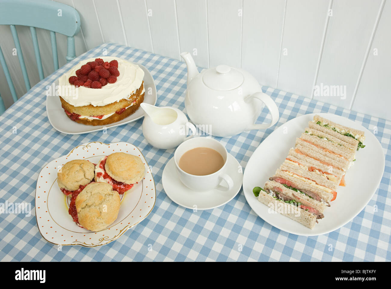 Tea with sandwiches and cakes Stock Photo Alamy