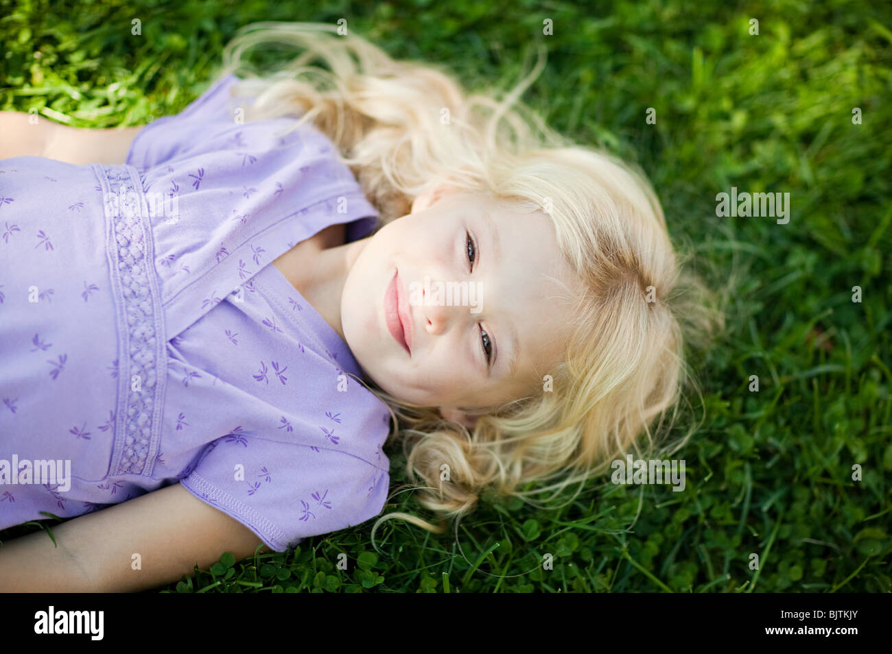 Girl lying on grass Stock Photo - Alamy