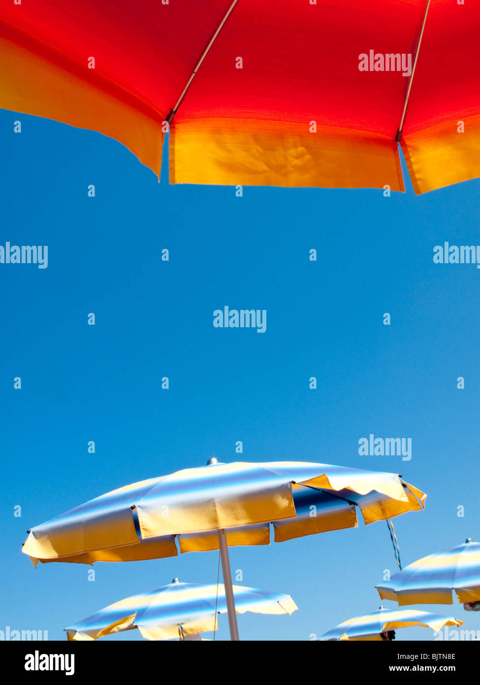 Colourful sunshades (umbrella) on beach with blue sky Stock Photo Alamy