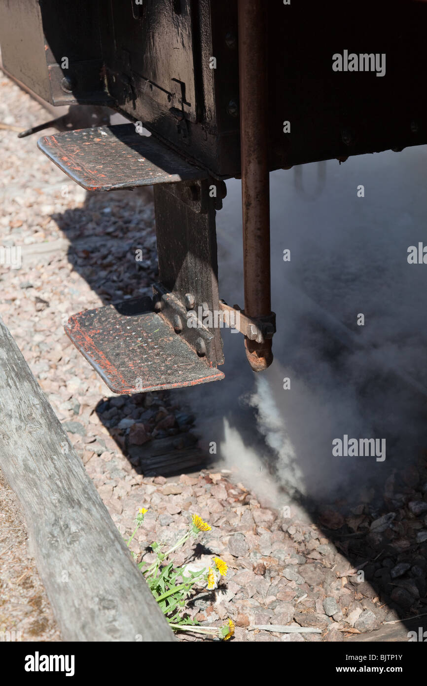 Step up to a locomotive with steam blowing out Stock Photo