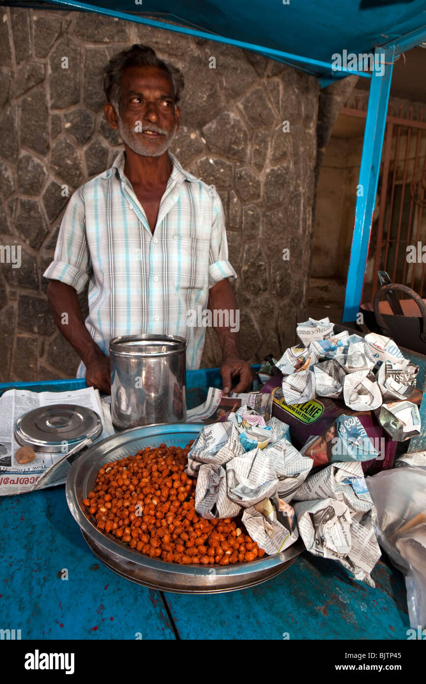 India, Kerala, Palakkad, roadside snack vendor selling packs of Channa Masala, spicy chick peas, at entrance to fort Stock Photo