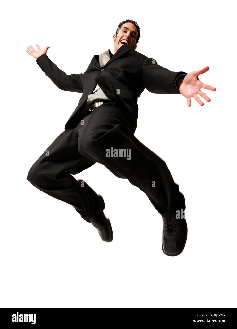 Man jumping with arms extended Stock Photo