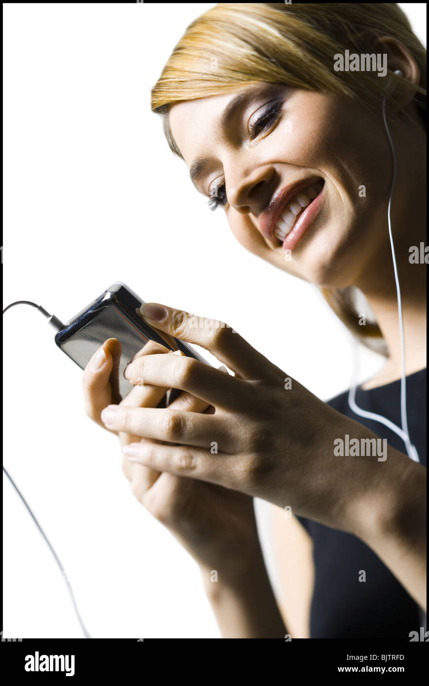 Woman with listening device and earbuds Stock Photo