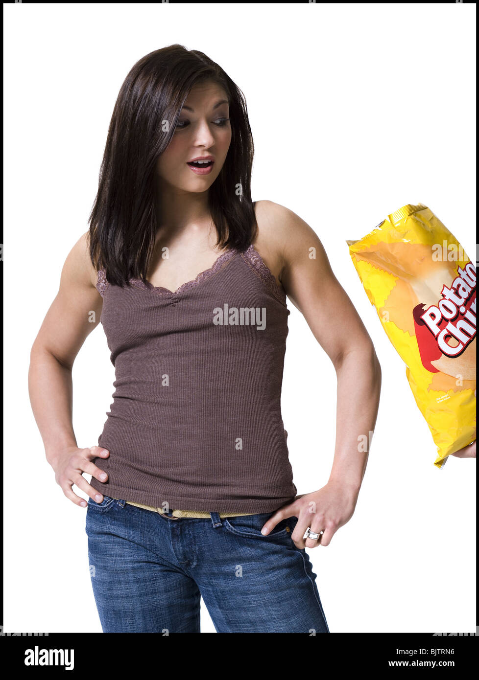 Woman tempted by potato chips Stock Photo