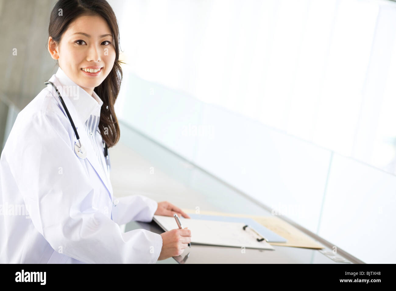 Doctor smiling at camera hi-res stock photography and images - Alamy