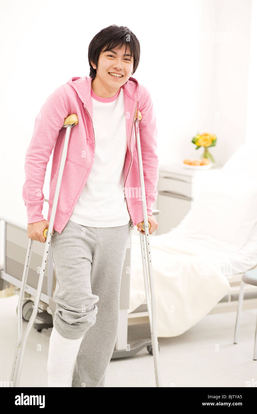 Man on crutches in the hospital Stock Photo Alamy