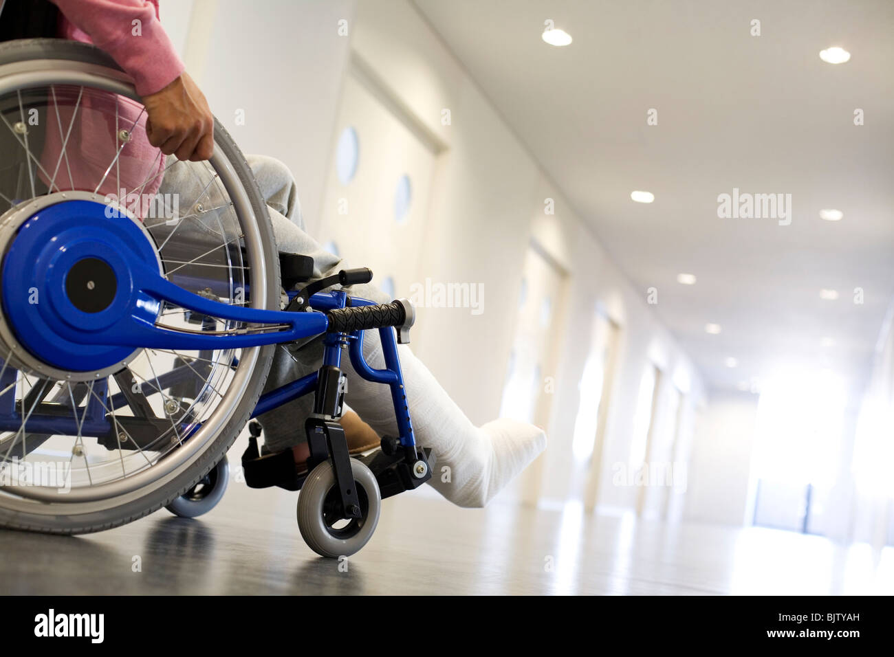 Man with broken leg in a wheelchair Stock Photo - Alamy