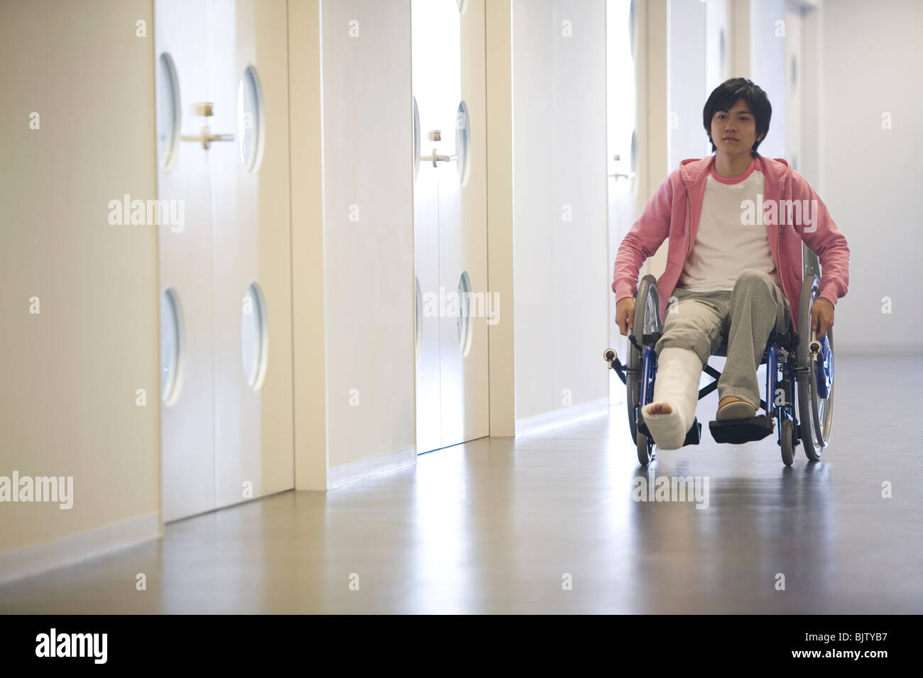 Man with broken leg in a wheelchair Stock Photo Alamy