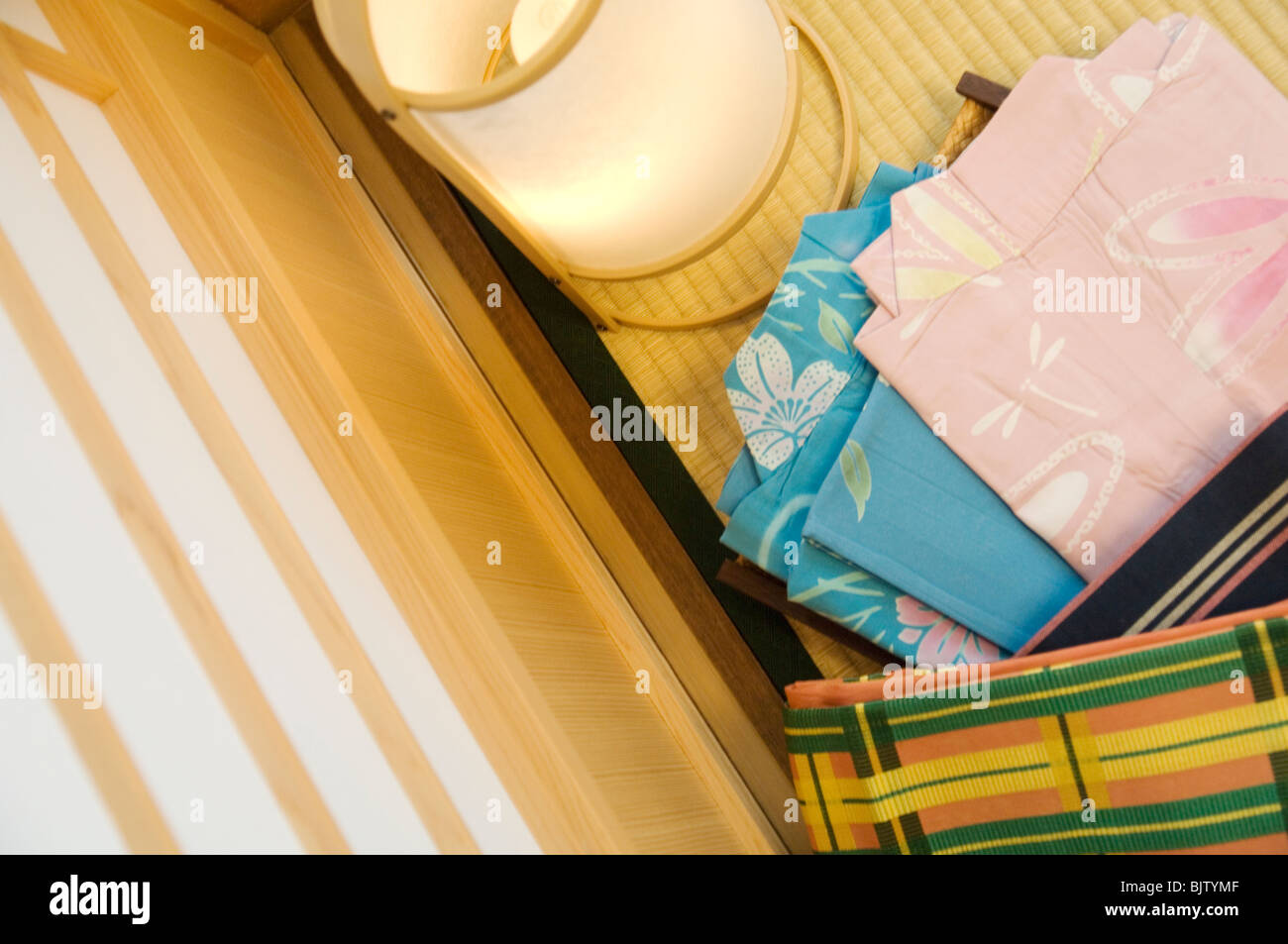 Folded yukata next to a lantern in a Japanese room Stock Photo