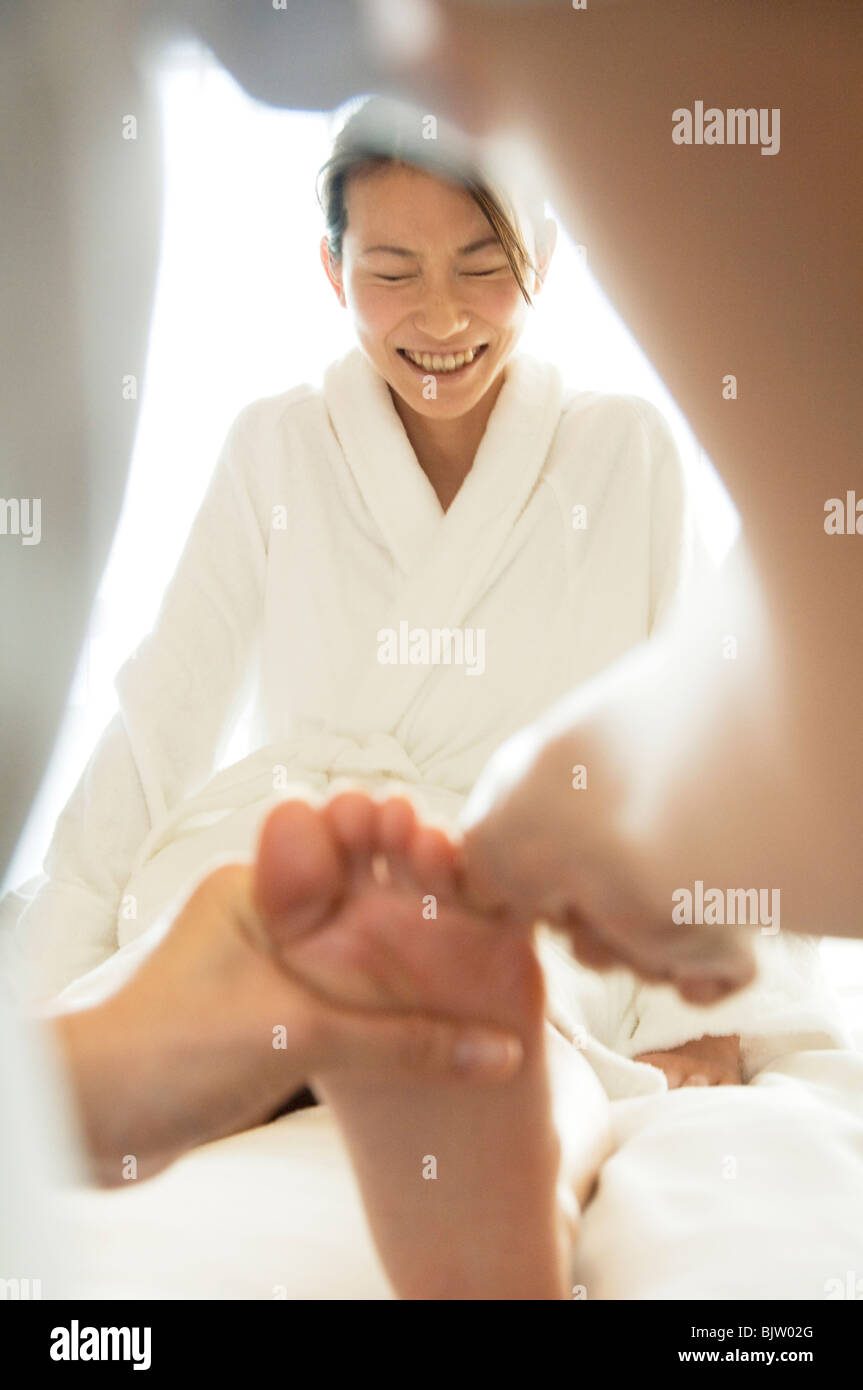 Woman laughs while receiving a foot massage Stock Photo Alamy
