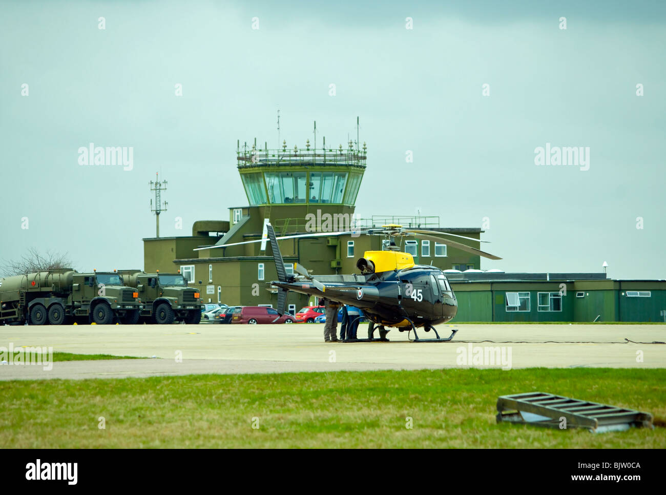 Air Traffic Control Tower Wattisham Airfield Suffolk With An Army Air Corps Squirrel Helicopter In The Foreground Stock Photo
