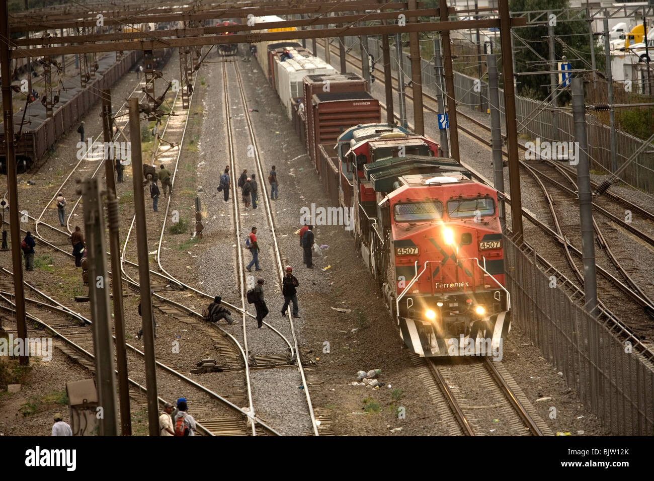 Undocumented Central American migrants traveling across Mexico to work in the United States jump a train in Mexico City, Mexico, Stock Photo