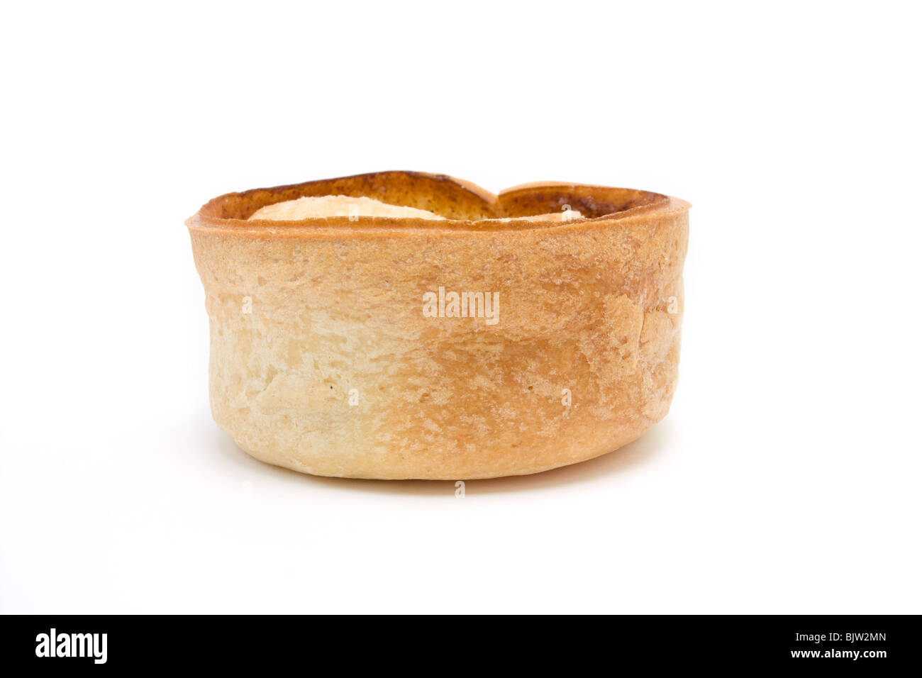 Small round scottish style Steak and Gravy Pie isolated against white background. Stock Photo