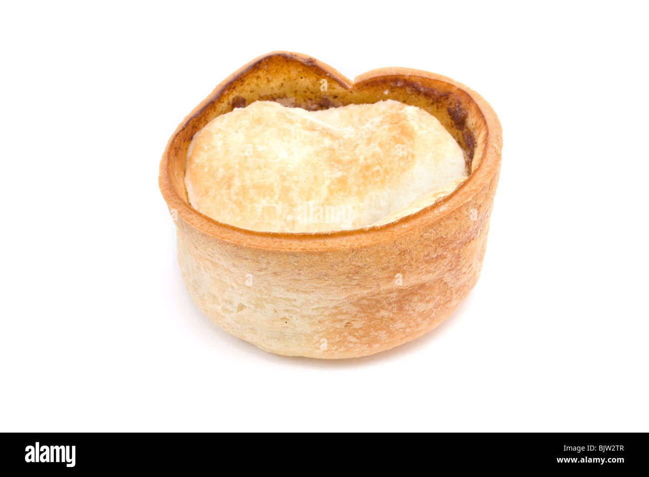 Small round scottish style Steak and Gravy Pie isolated against white background. Stock Photo