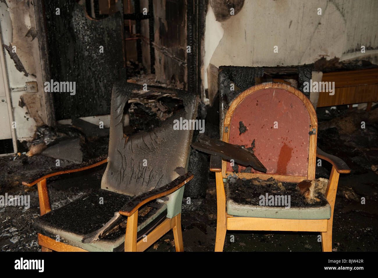 Burnt chairs after fire in old peoples home Stock Photo