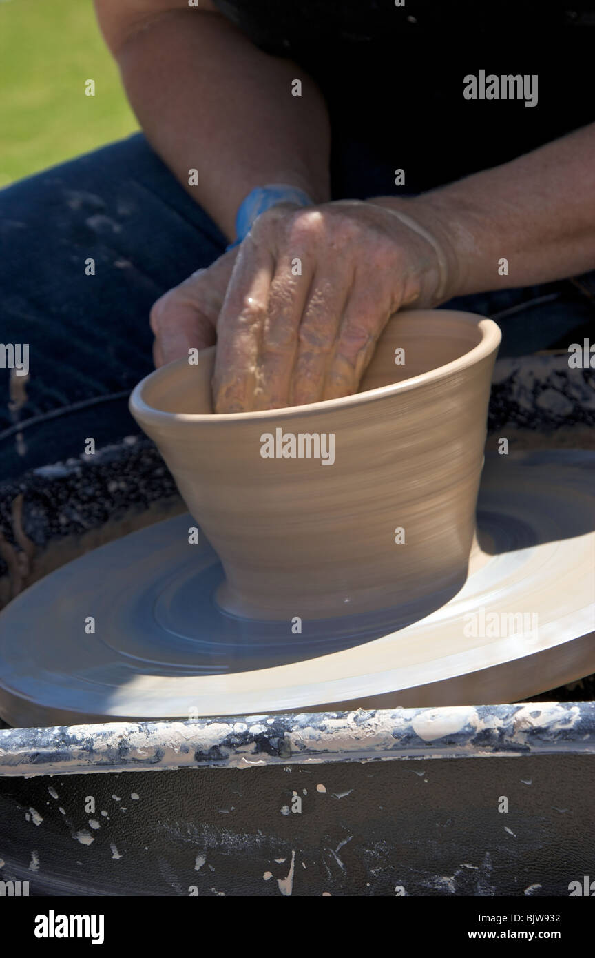 Close up of bowl being formed from wet clay by artist on potter's wheel Stock Photo Alamy