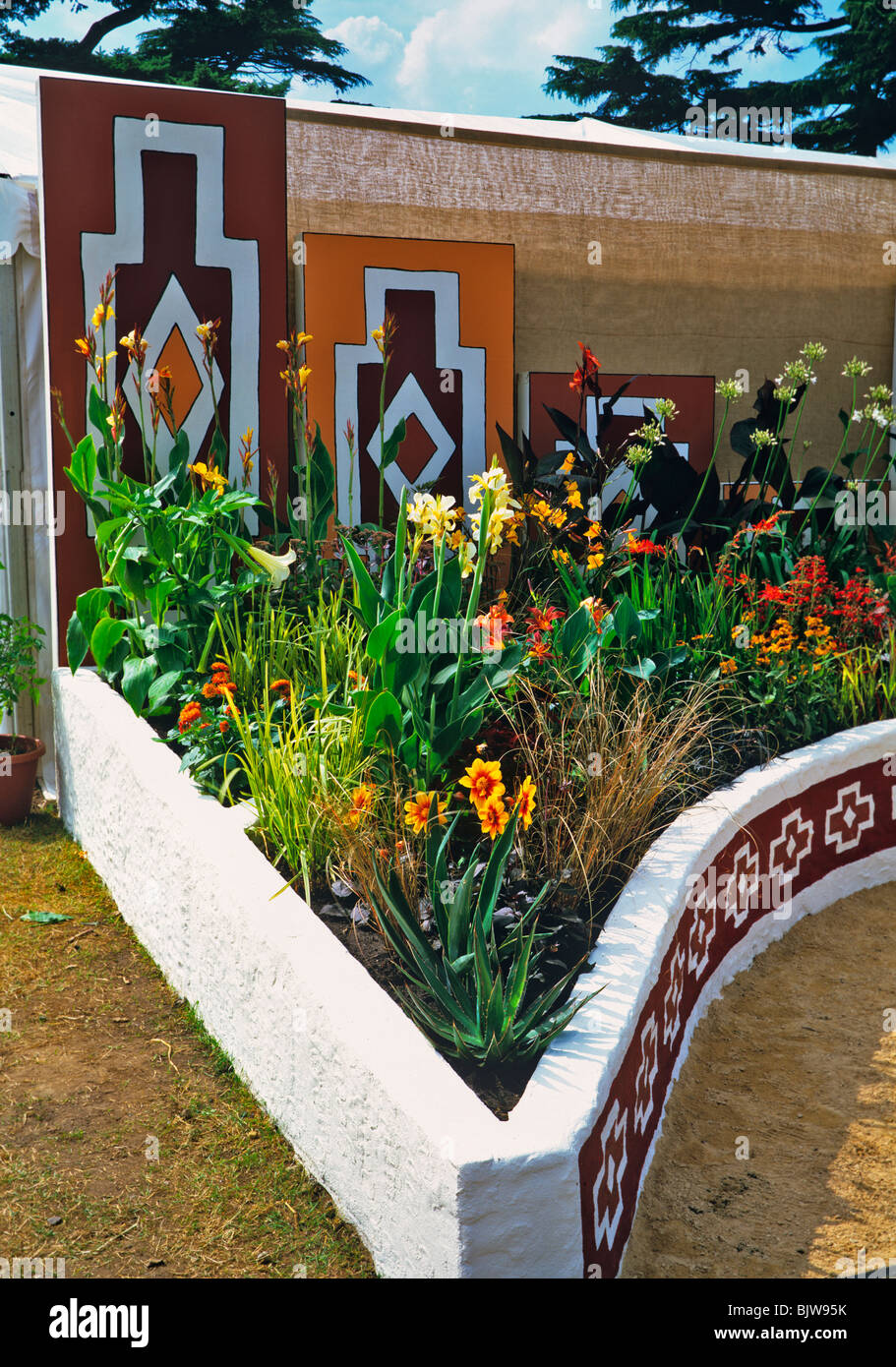 Colourful garden with flower borders in African style decoration in