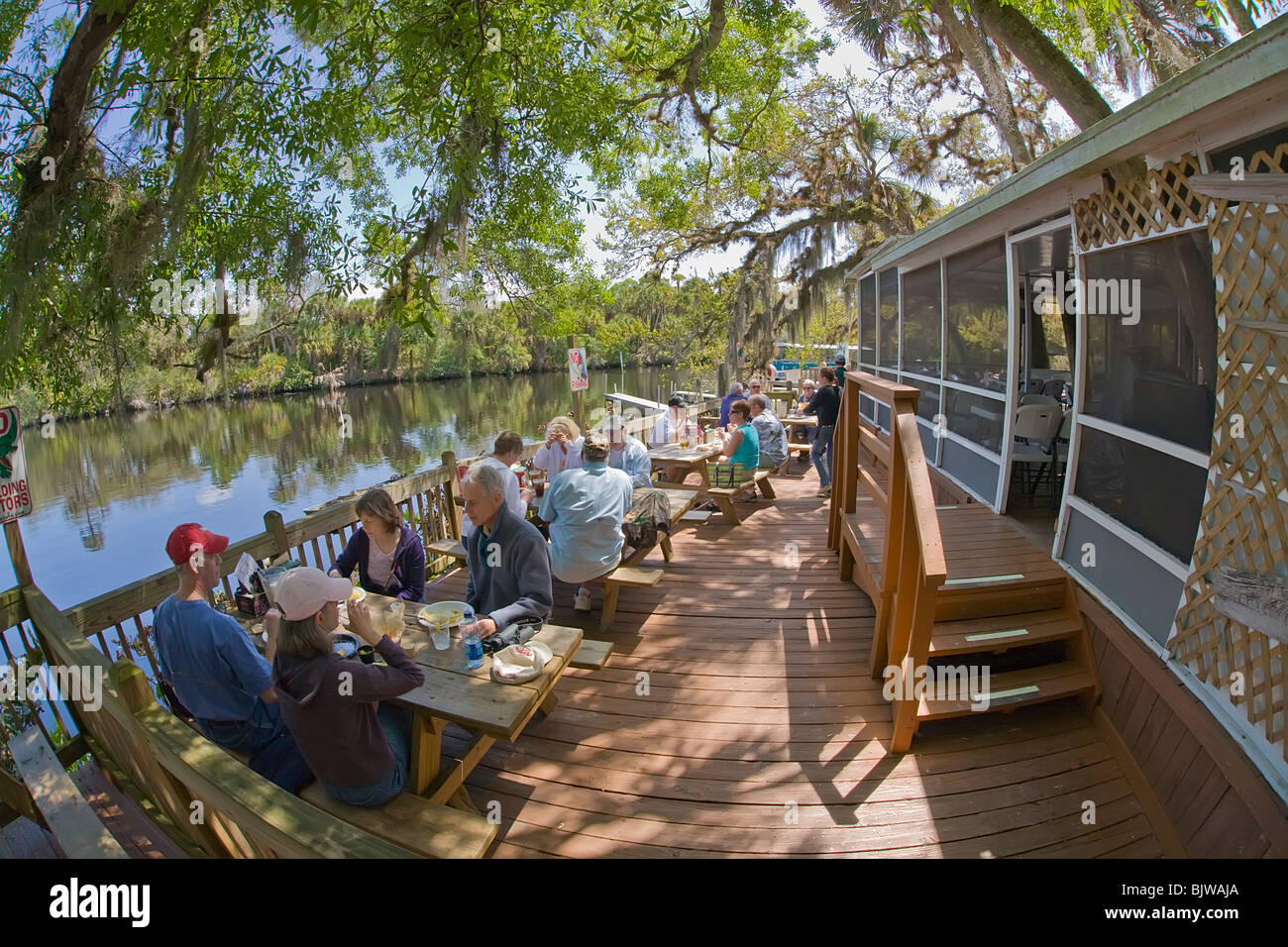 People eating in outdoor dining area at Snook Haven fish camp on the