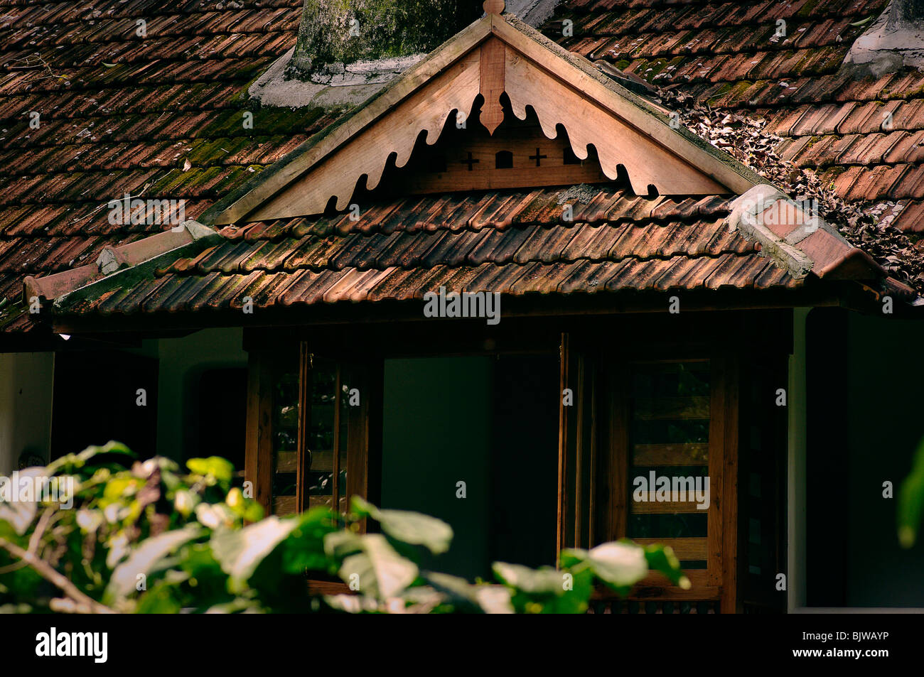 slanted roof of a cootage built in kerala style architecture Stock Photo