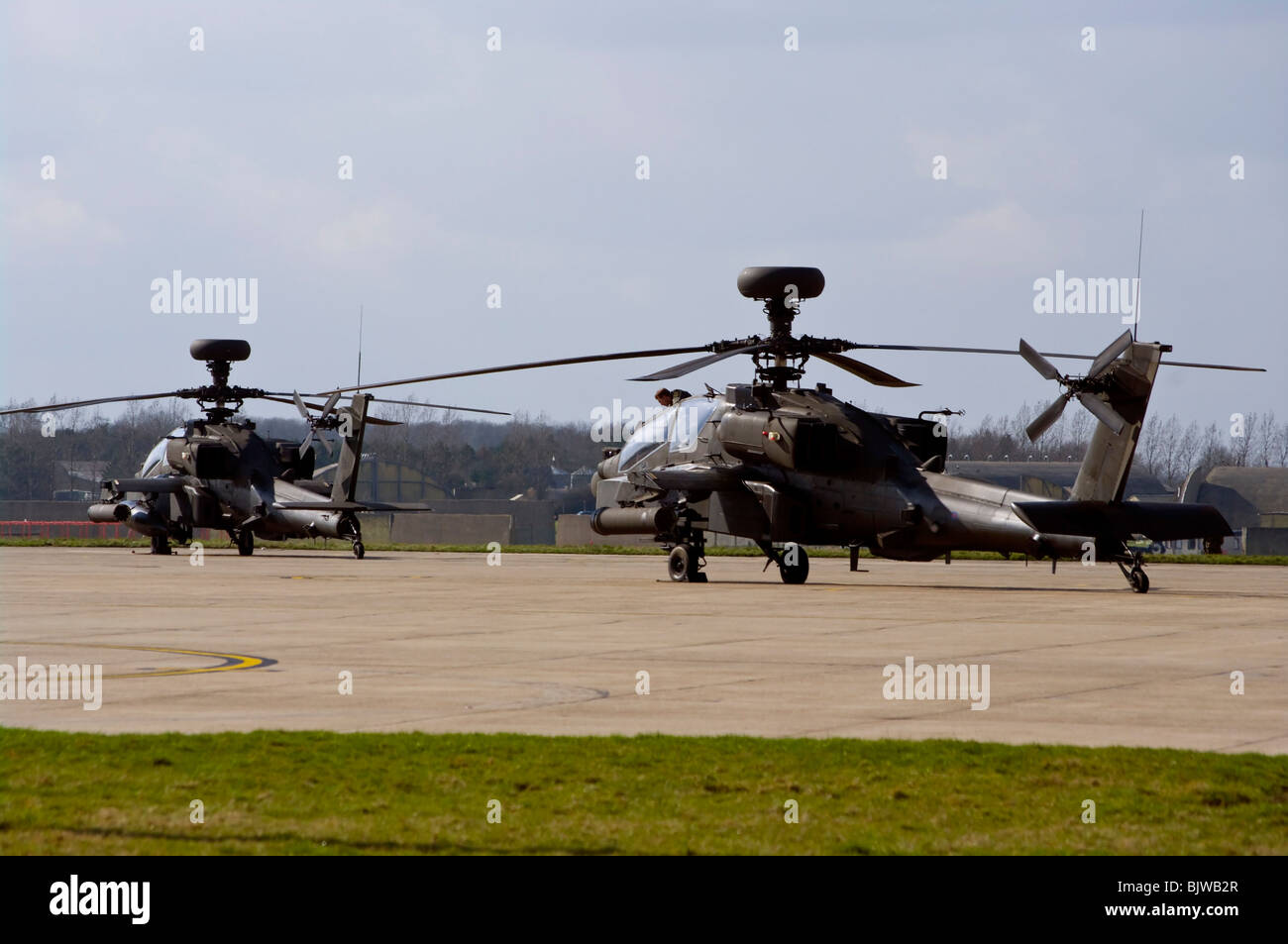 2 British Army Westland Attack Helicopters WAH-64 MK1 Apache Longbow On The Tarmac At Wattisham Airfield Suffolk Stock Photo