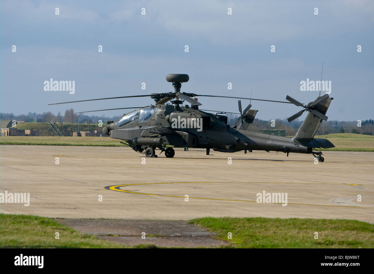 A British Army Westland Attack Helicopter WAH-64 MK1 Apache Longbow On The Tarmac At Wattisham Airfield Suffolk Stock Photo