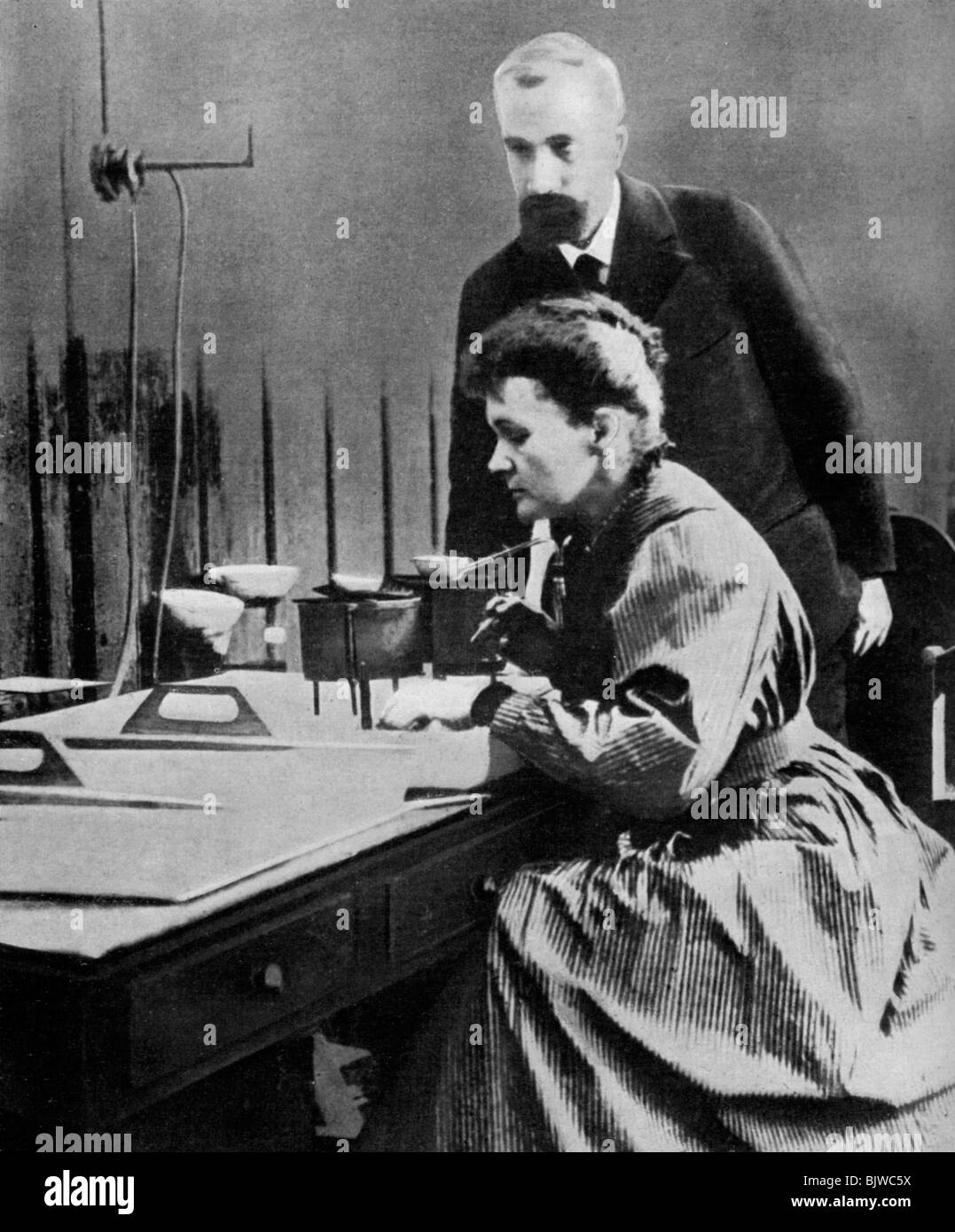 Pierre and Marie Curie in their laboratory, 1898 (1951). Artist: Unknown Stock Photo