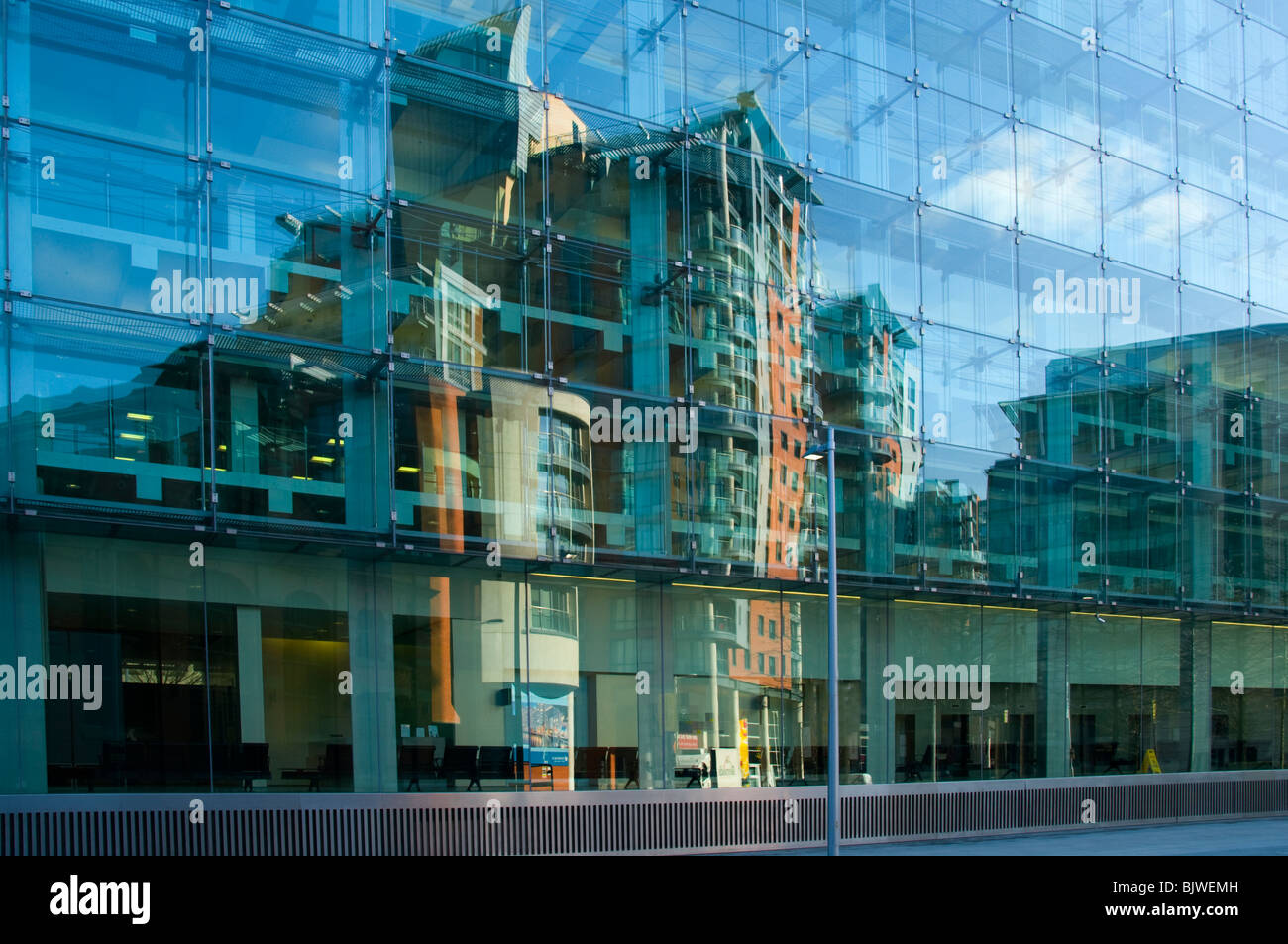 Reflections in the window of the Civil Justice Centre building, Spinningfields, Manchester, England, UK. Stock Photo