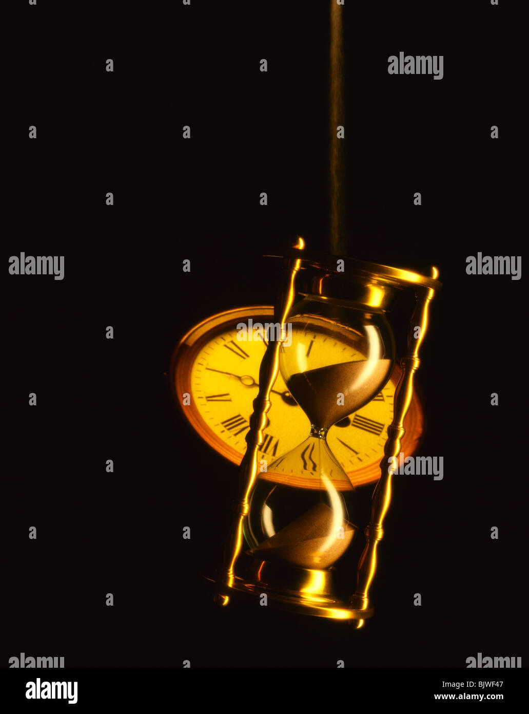 Hour glass with Projected Clock Face Stock Photo