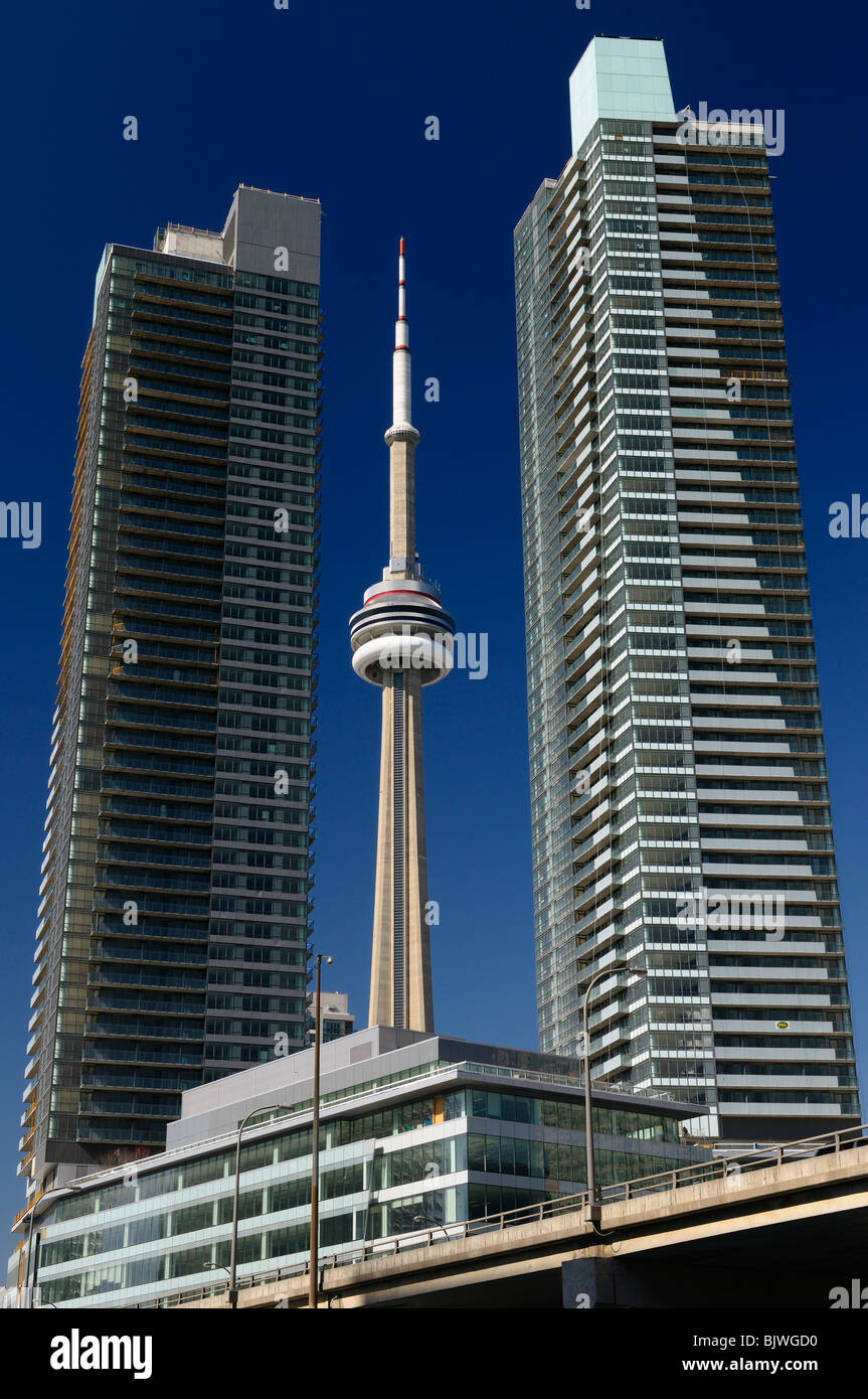 New unfinished downtown high rise Condo towers in Toronto with the CN tower against a blue sky Stock Photo