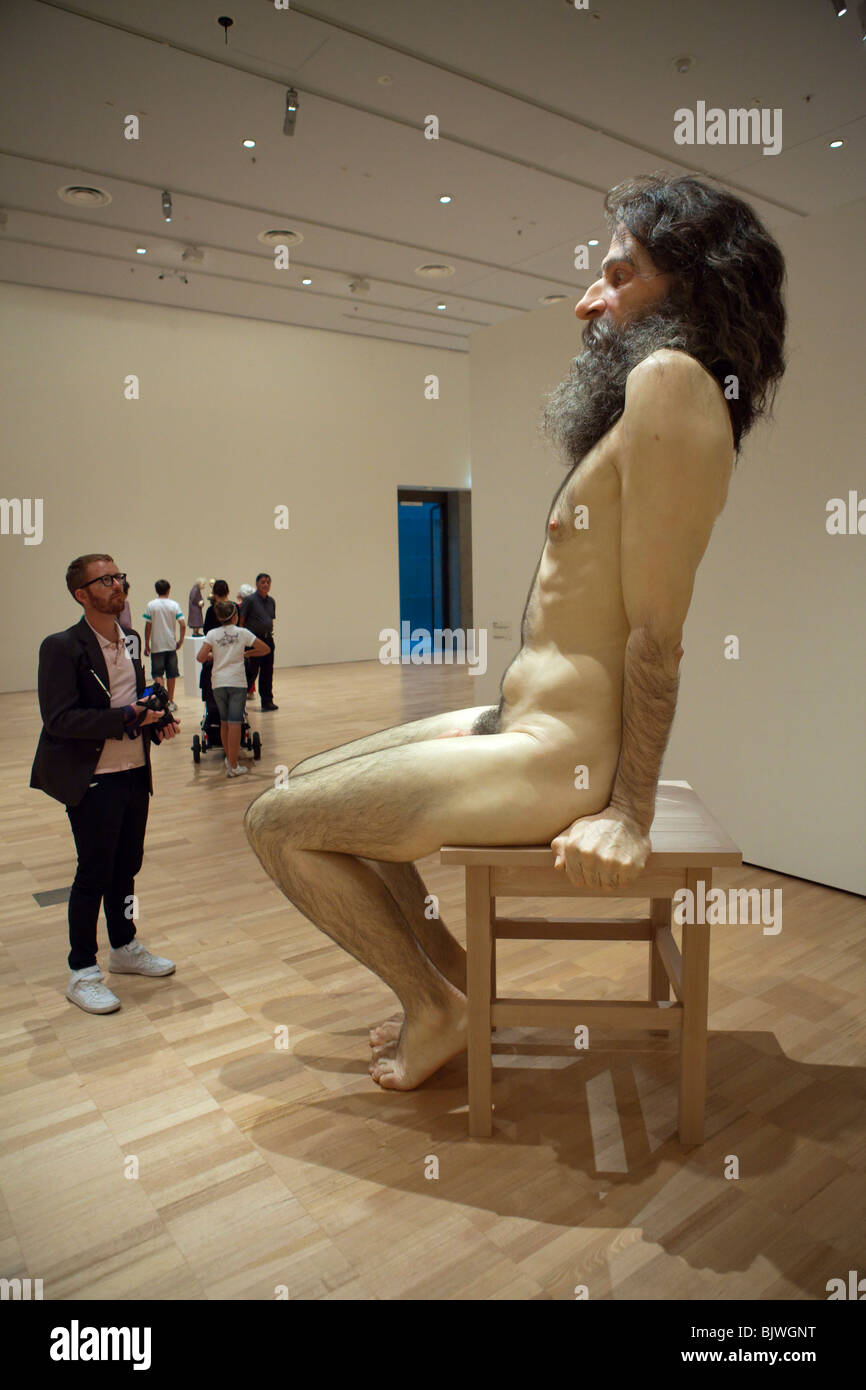 Ron Mueck's Bearded Man Sitting on a Chair Sculpture Stock Photo