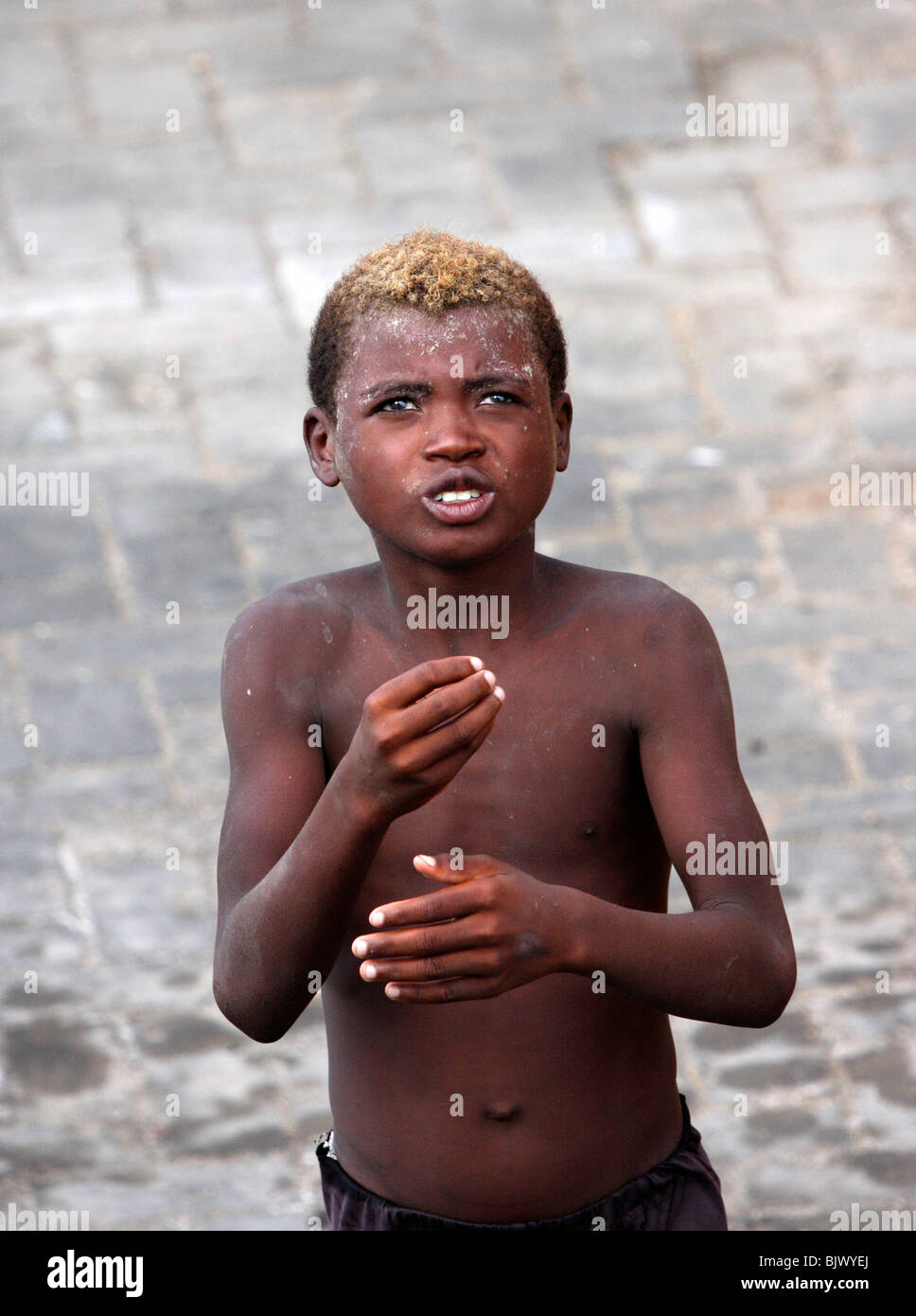 hungry poor african street kid begging for food,madagascar,africa Stock Photo