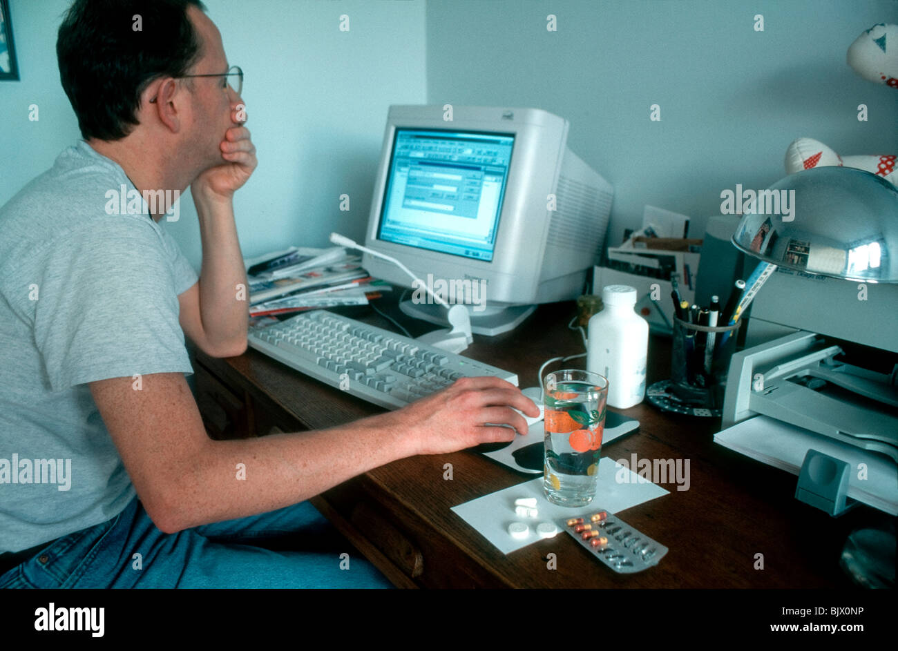 H.I.V.Positive Man with his AIDS Drugs Medication , Working from Home