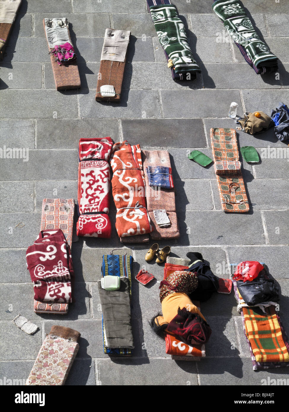 Prayer cushions wait for pilgrims' prostrations in Barkhor Square in