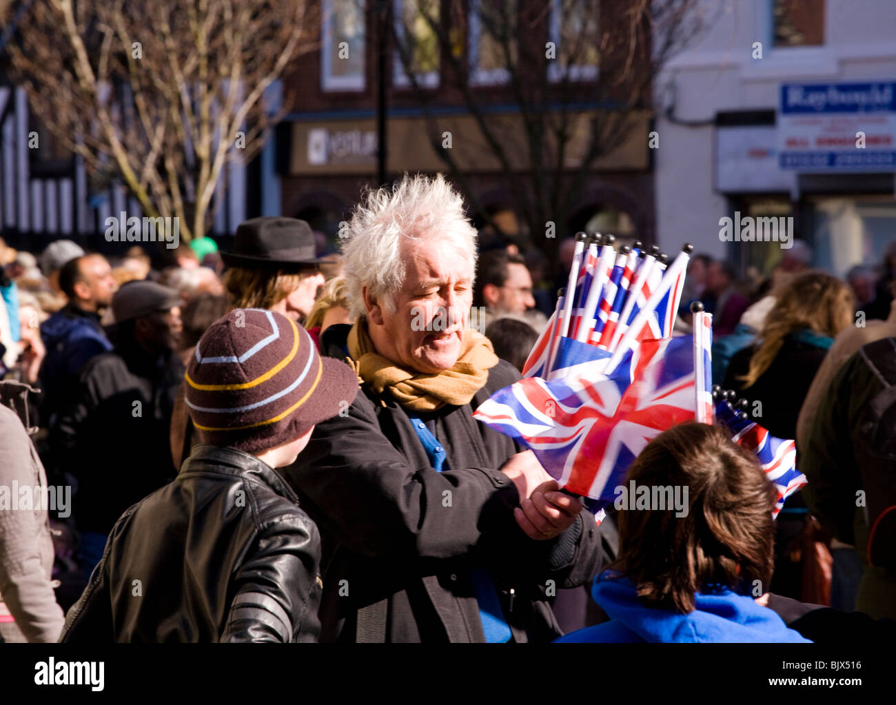 A man sells Union Jack flags outside Derby Cathedral during a state visit by the Queen for Maundy Thursday at Easter Stock Photo