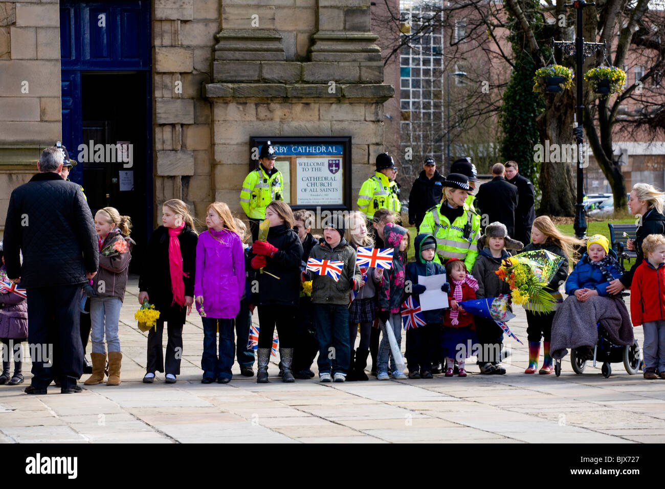 A group of young children line up outside Derby Cathedral to meet the Queen after the Maundy Money ceremony at Easter. Stock Photo