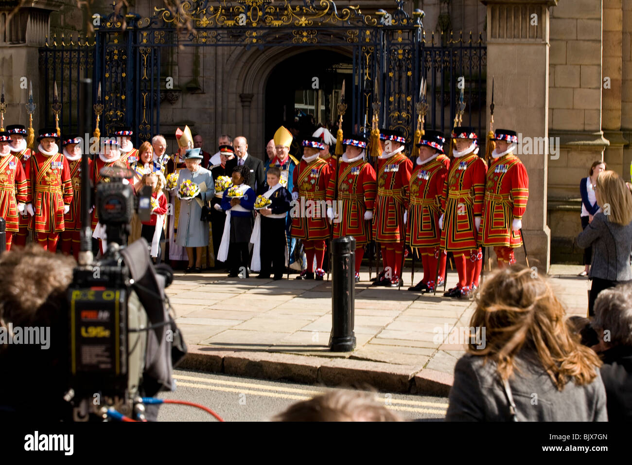 Beefeaters and Clergymen line up outside the gates of Derby Cathedral with The Queen and Prince Philip for Easter Maundy. Stock Photo