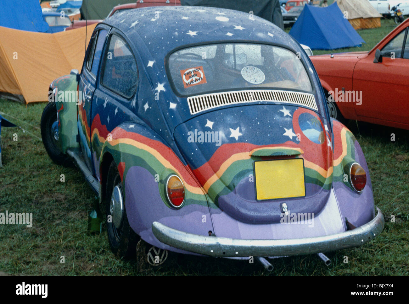 Rainbow Painted VW Beetle Car At Glastonbury Festival Pilton Somerset UK Europe Stock Photo
