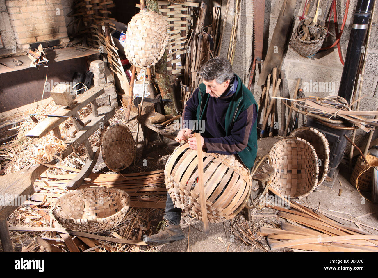 Owen Jones making Oak Swill Basket in the Lake District,is the only craftsman making swill baskets in the country. Stock Photo