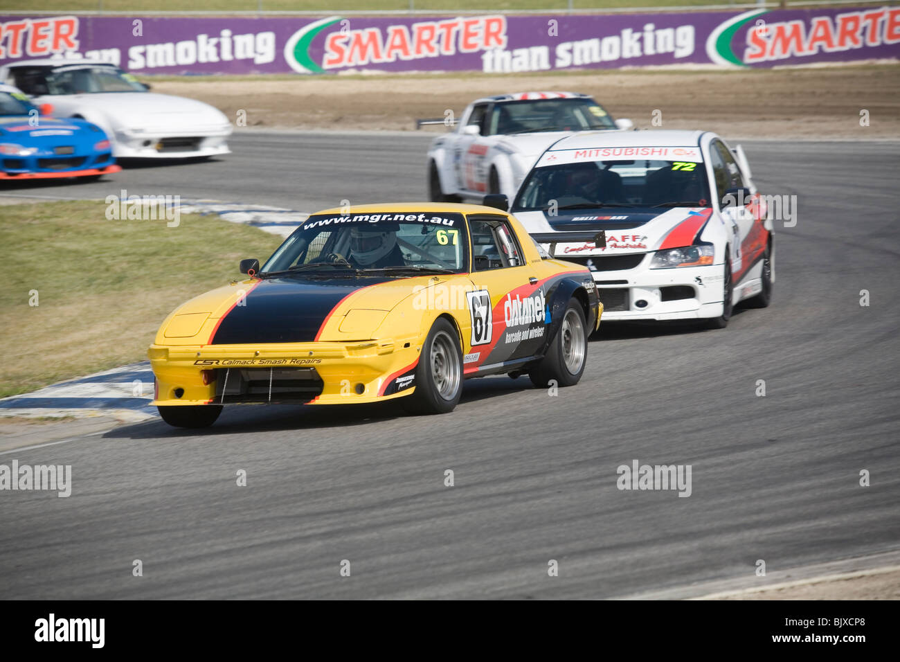 Mazda RX7 race car leading the pack around a corner Stock Photo