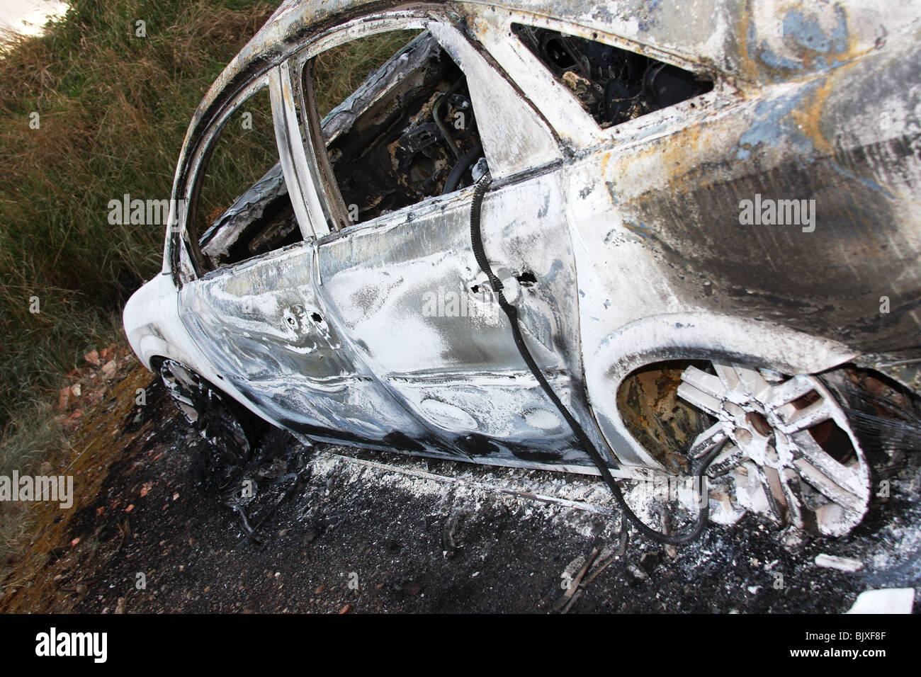 Stolen, dumped and burnt out car. Stock Photo