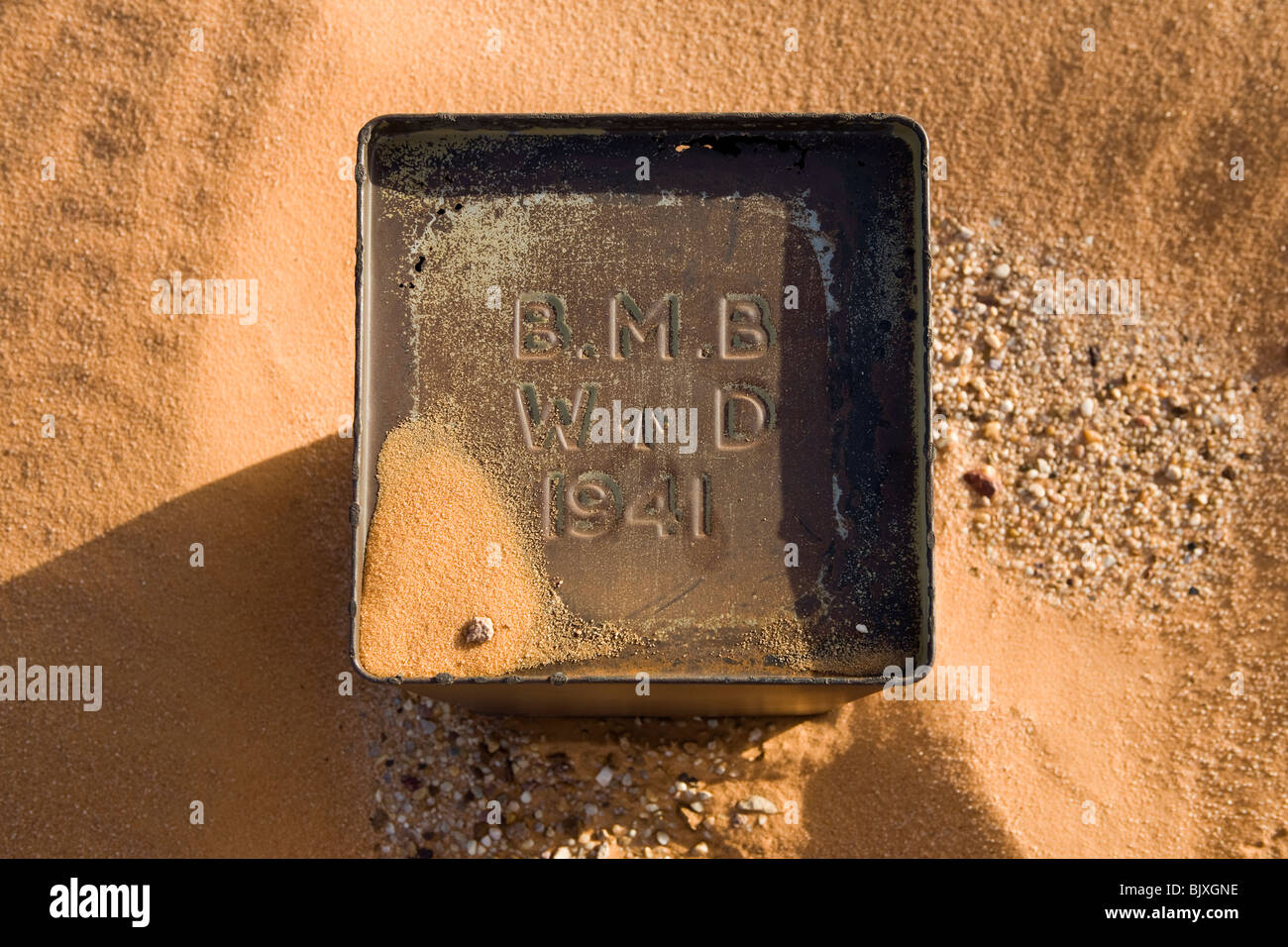 Fuel tin close to abandoned Ford 30 CWT CMP truck from 1941/42 era sinking in the sand of the Western Desert, Egypt Stock Photo