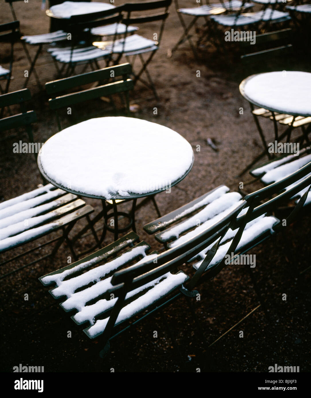 Tables and chairs covered by snow Stock Photo