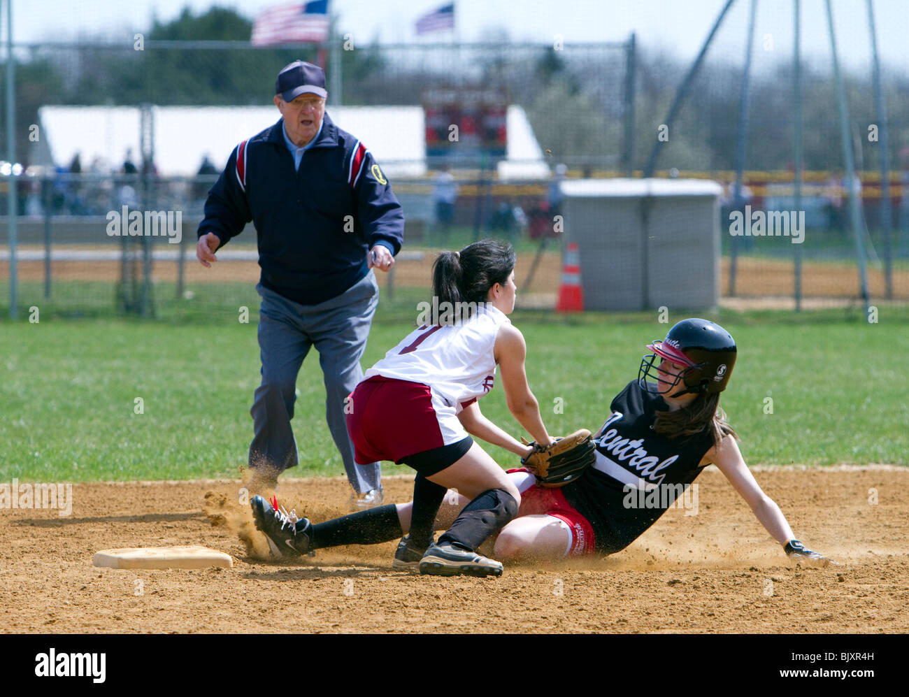 Girls high school softball game. Runner tagged out at second. Umpire