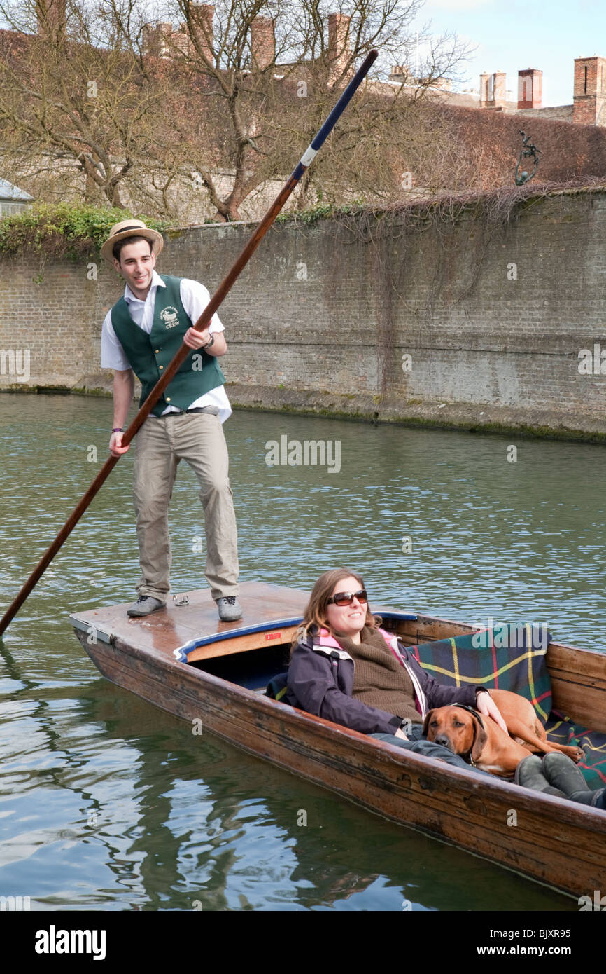 Cambridge punting - A tourist and her dog being punted on the River Cam, Cambridge, UK Stock Photo