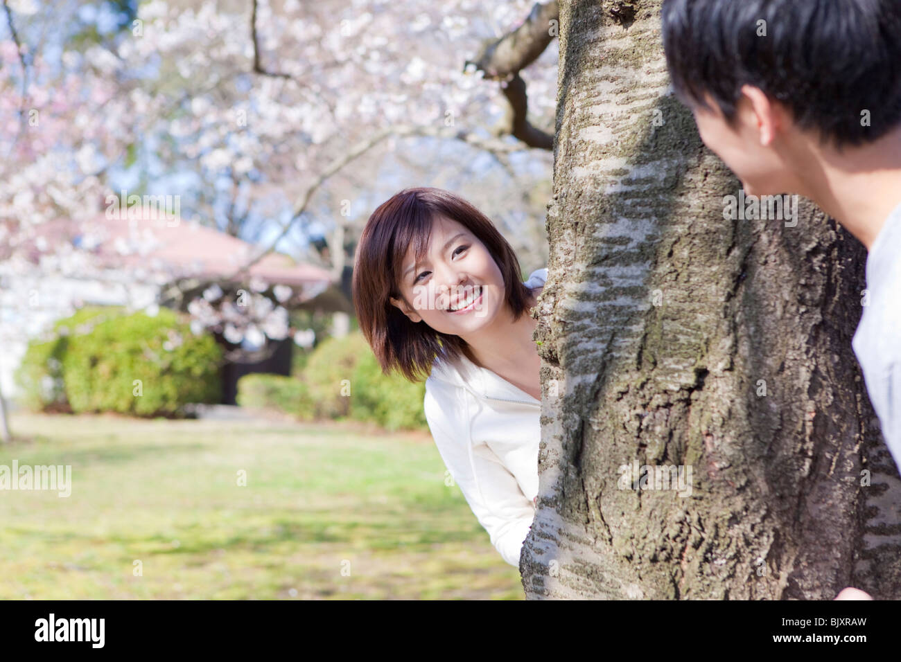 Young couple playing in a park Stock Photo - Alamy