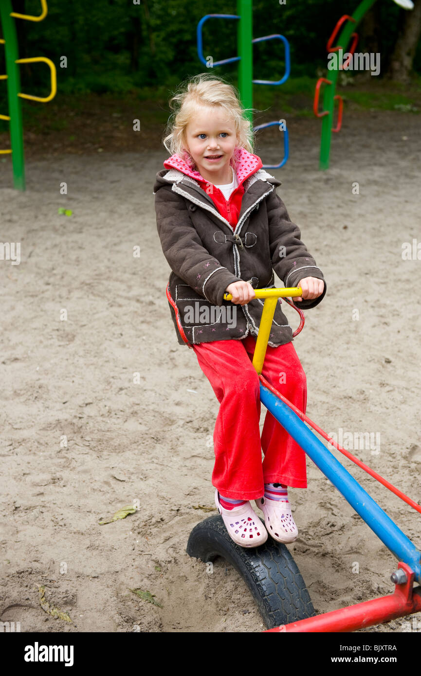 Little girl is playing at the playground Stock Photo - Alamy