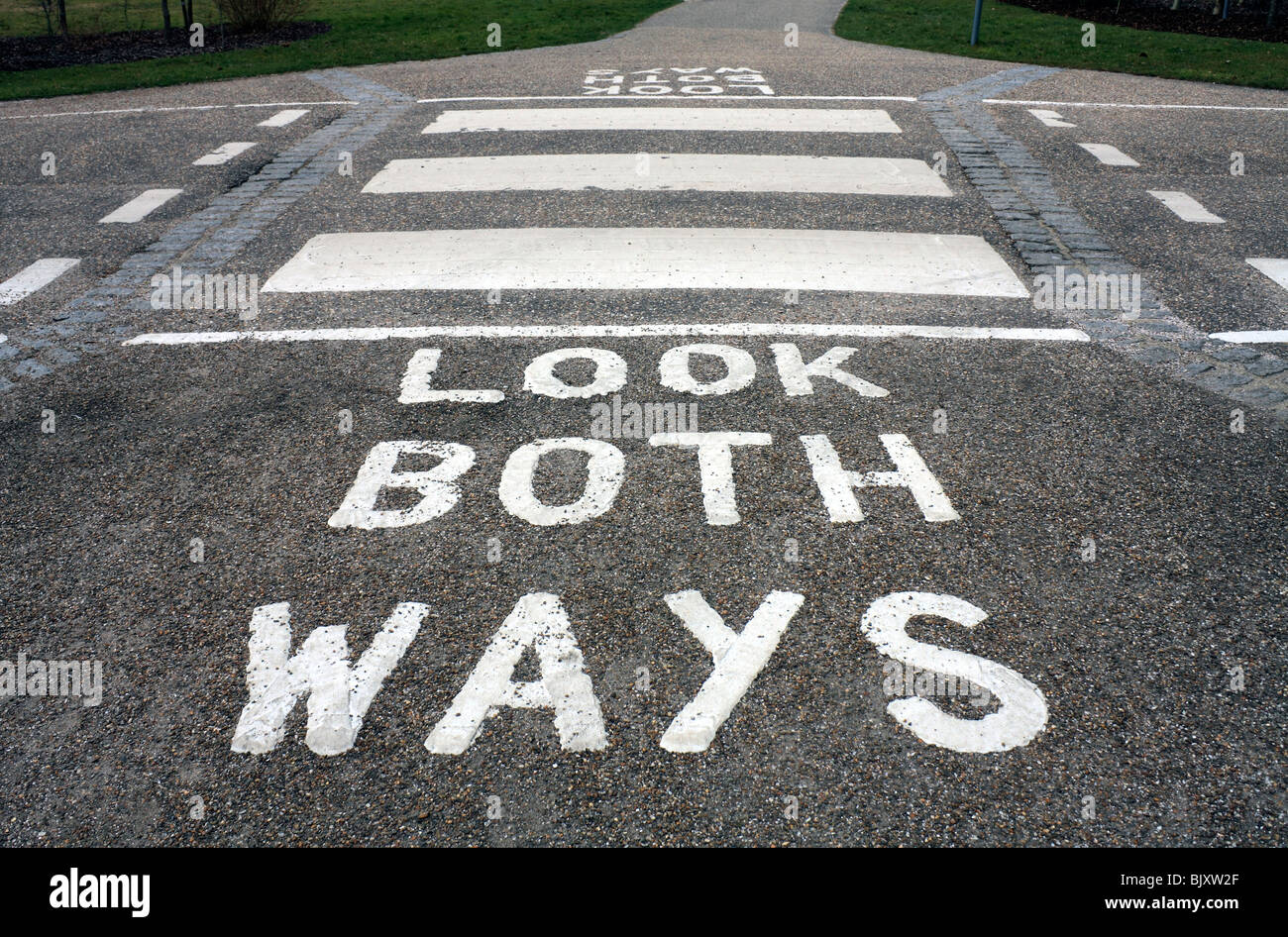 Look both ways painted road marking and zebra crossing, England UK