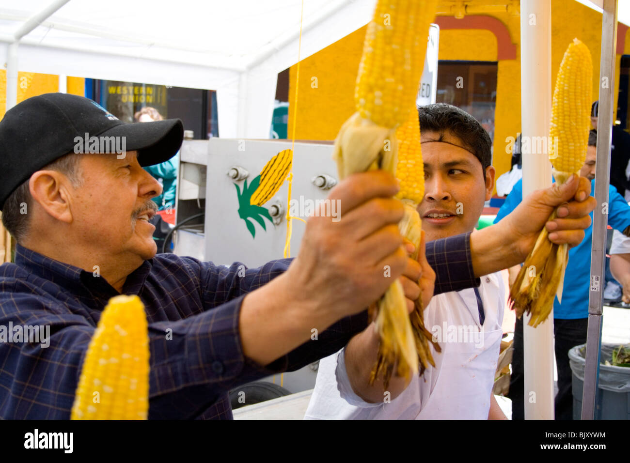 Hispanic food vendors selling their roasted corn on the cob age 60 and 18. Cinco de Mayo Fiesta